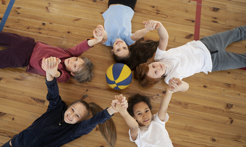 medium-shot-kids-laying-gym-floor